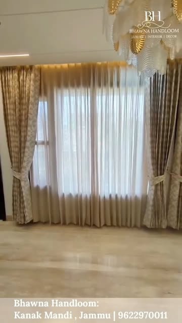 Gold and sheer curtains in a finished living room